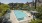 a pool with lounge chairs and umbrellas